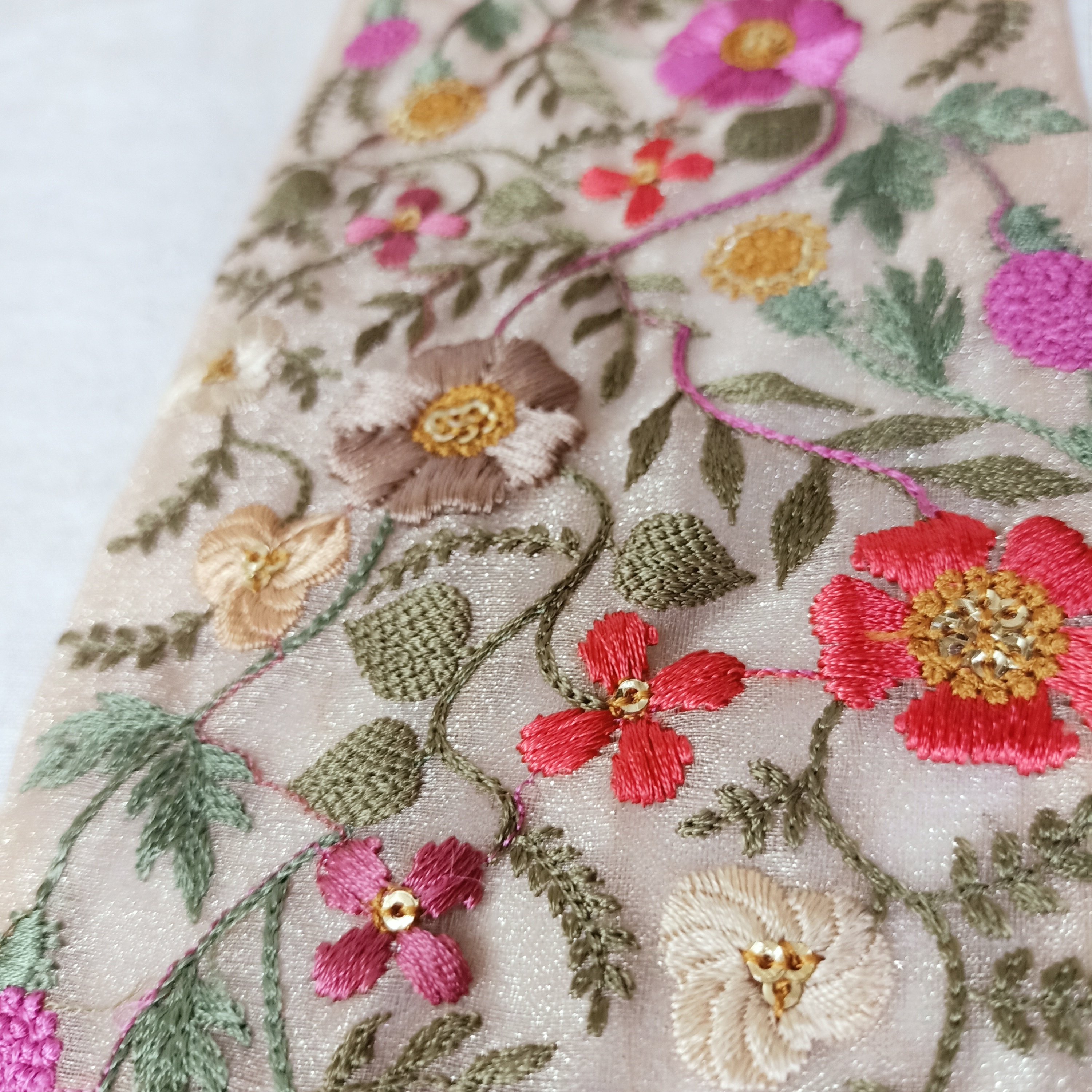delicate floral embroidered ribbons with pastel colored flowers available in broad sizes suitable for use as trims and borders