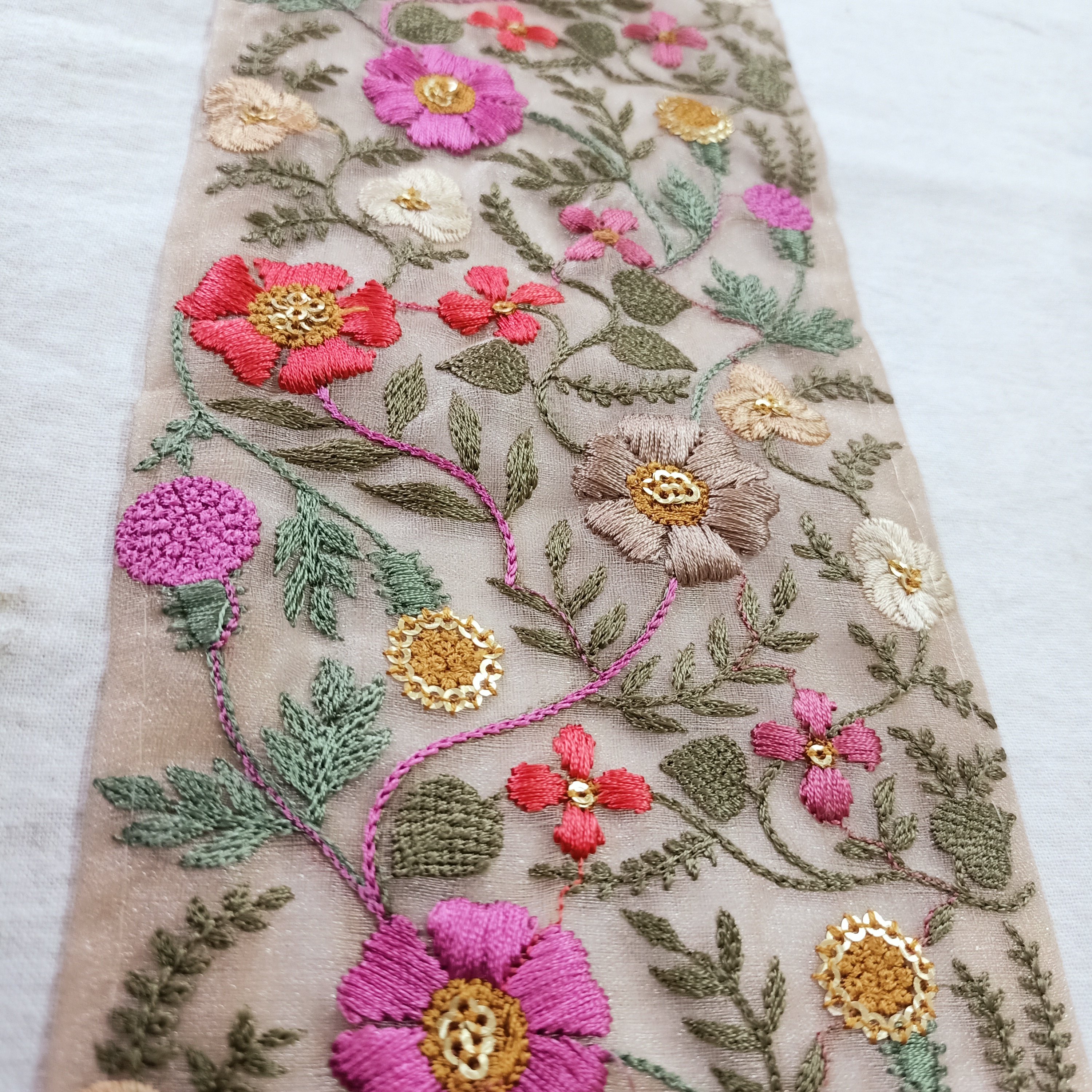 delicate floral embroidered ribbons with pastel colored flowers available in broad sizes suitable for use as trims and borders