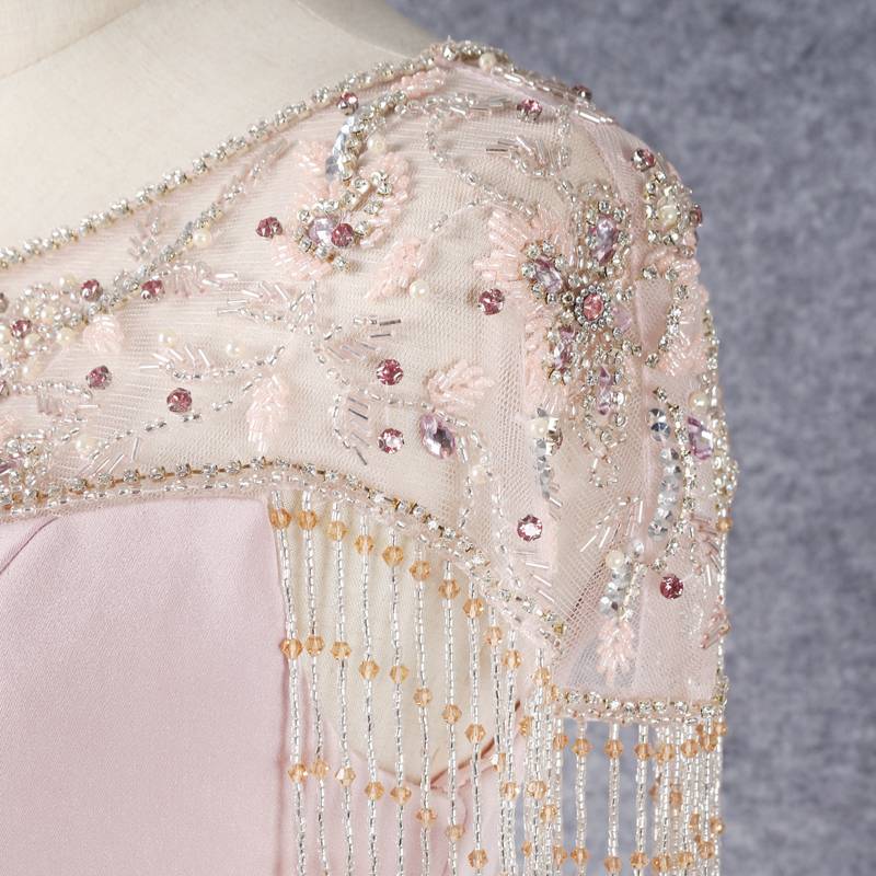 Fracked beaded evening dress covering the arm and covering the small belly