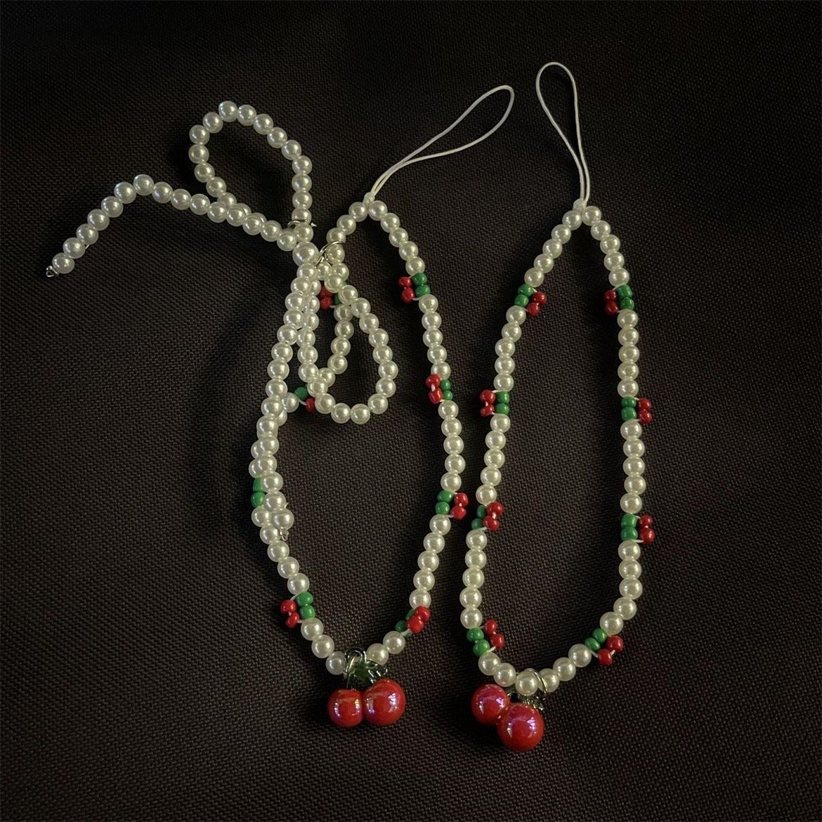 Korean niche cherry ins style fashion cute bow beaded mobile phone lanyard bag pendant transparent pearl