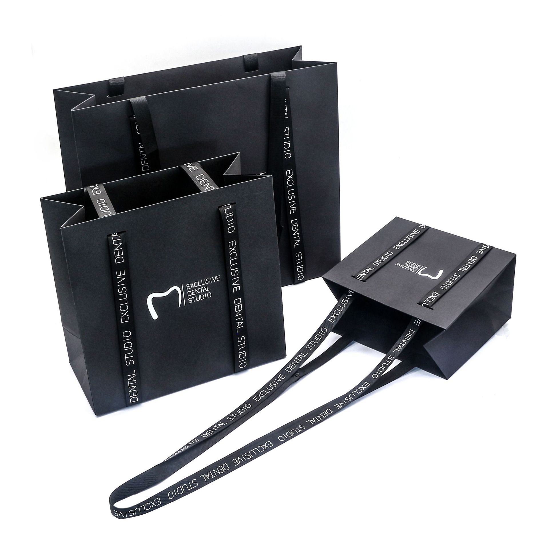 Wholesale black ivory board paper gift packaging with handles shopping bag with custom logo for clothing shoes flower paper bag