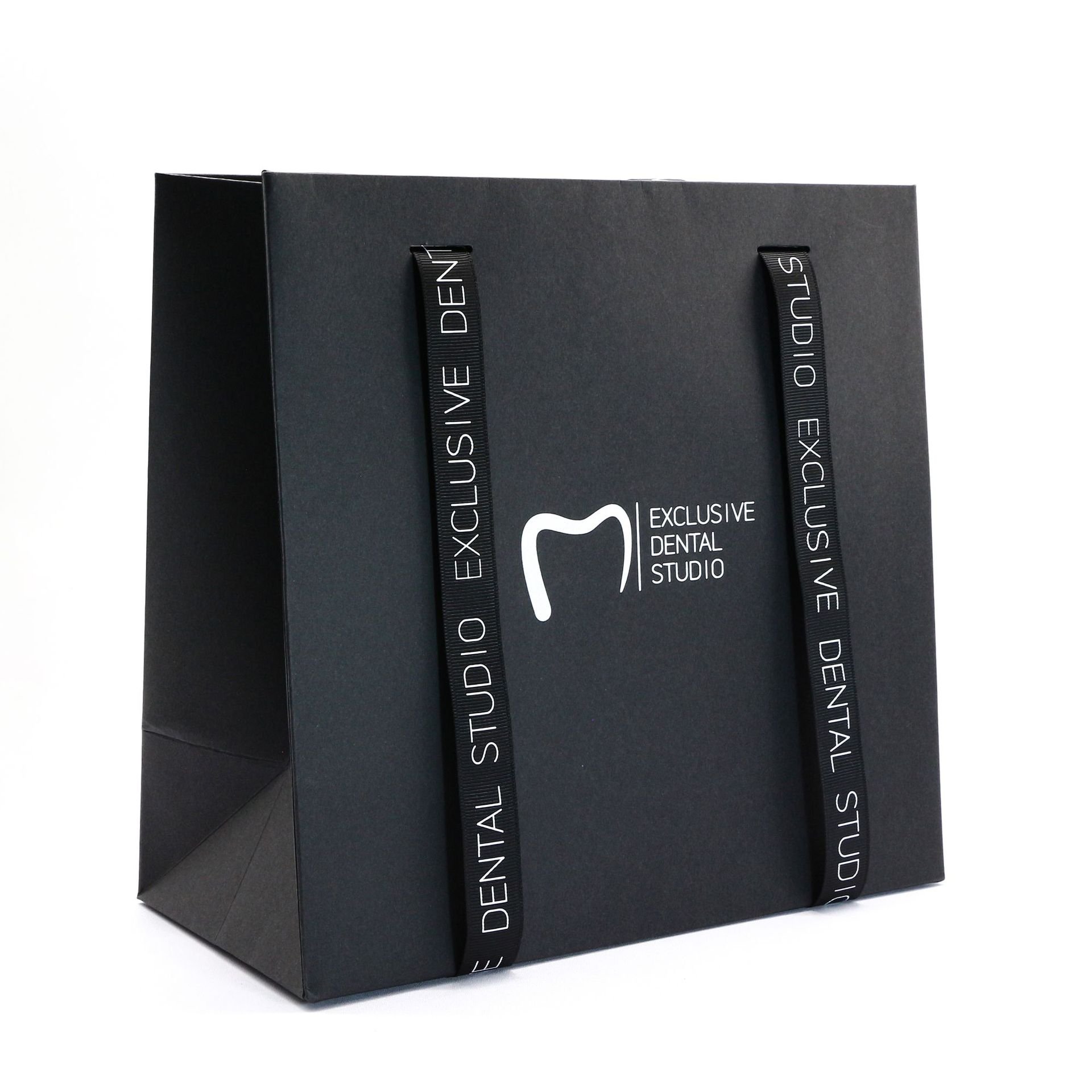 Wholesale black ivory board paper gift packaging with handles shopping bag with custom logo for clothing shoes flower paper bag