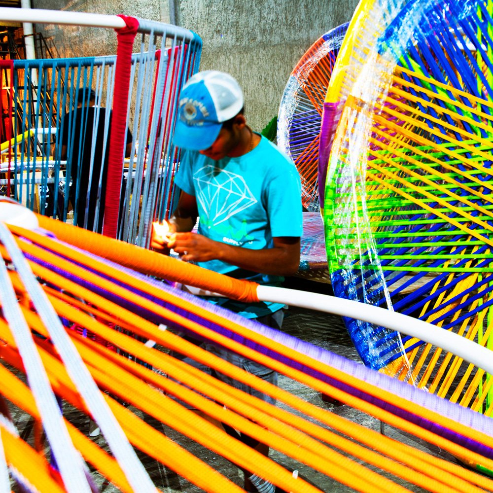 Los Trompos " Spinning Tops " is a place where people play interactive games connected by colorful woven tapes