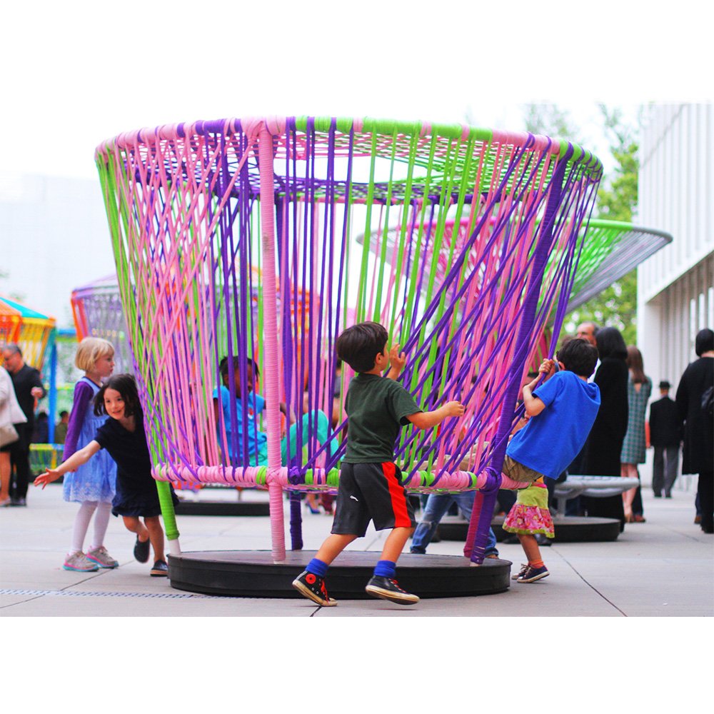 Los Trompos " Spinning Tops " is a place where people play interactive games connected by colorful woven tapes