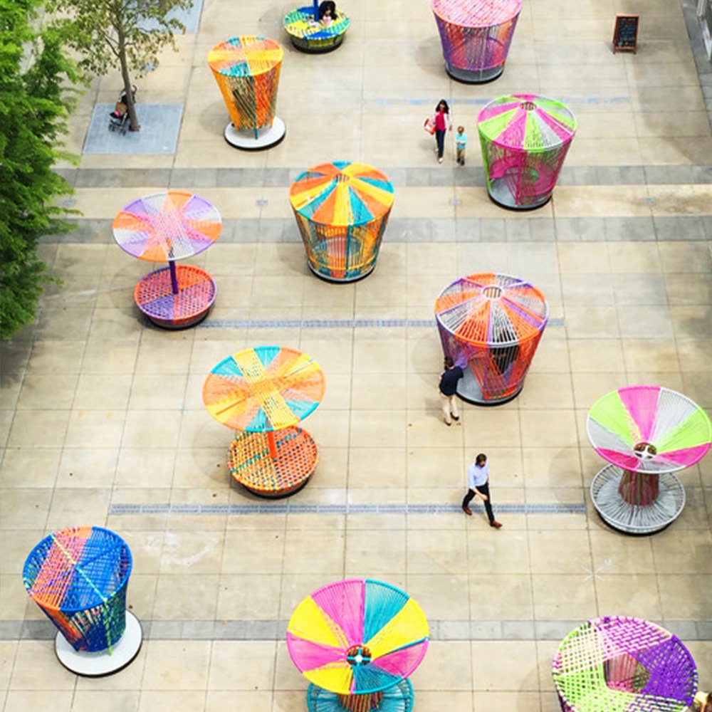 Los Trompos " Spinning Tops " is a place where people play interactive games connected by colorful woven tapes