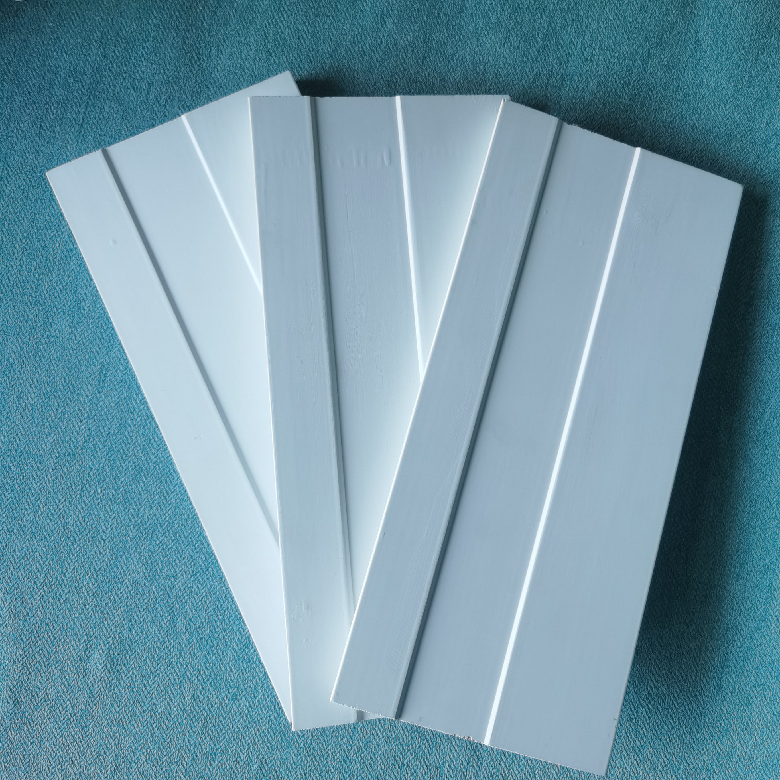white gesso coating and primed pine door frame flat door jamb wooden baseboard skirting moulding