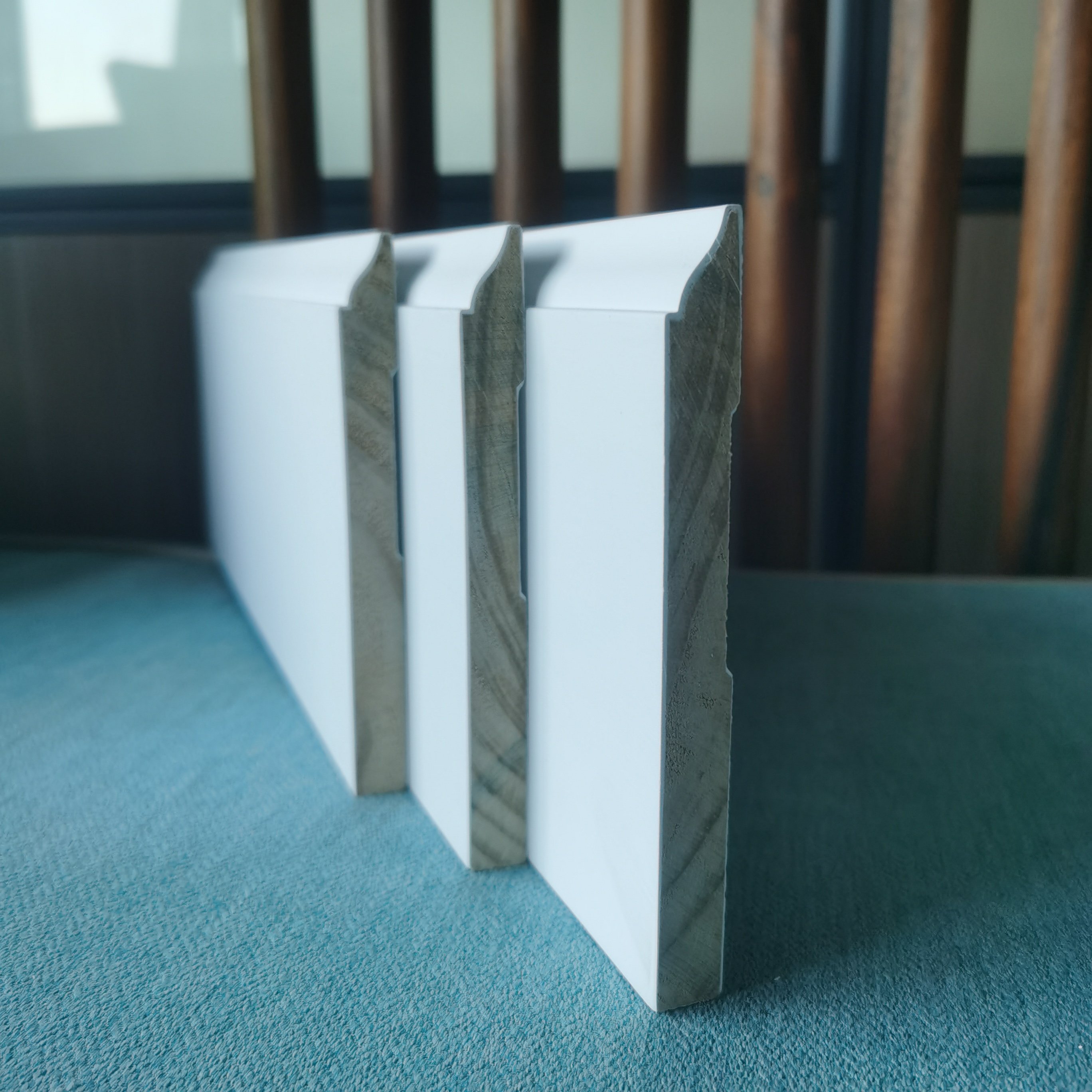 white gesso coating and primed pine door frame flat door jamb wooden baseboard skirting moulding