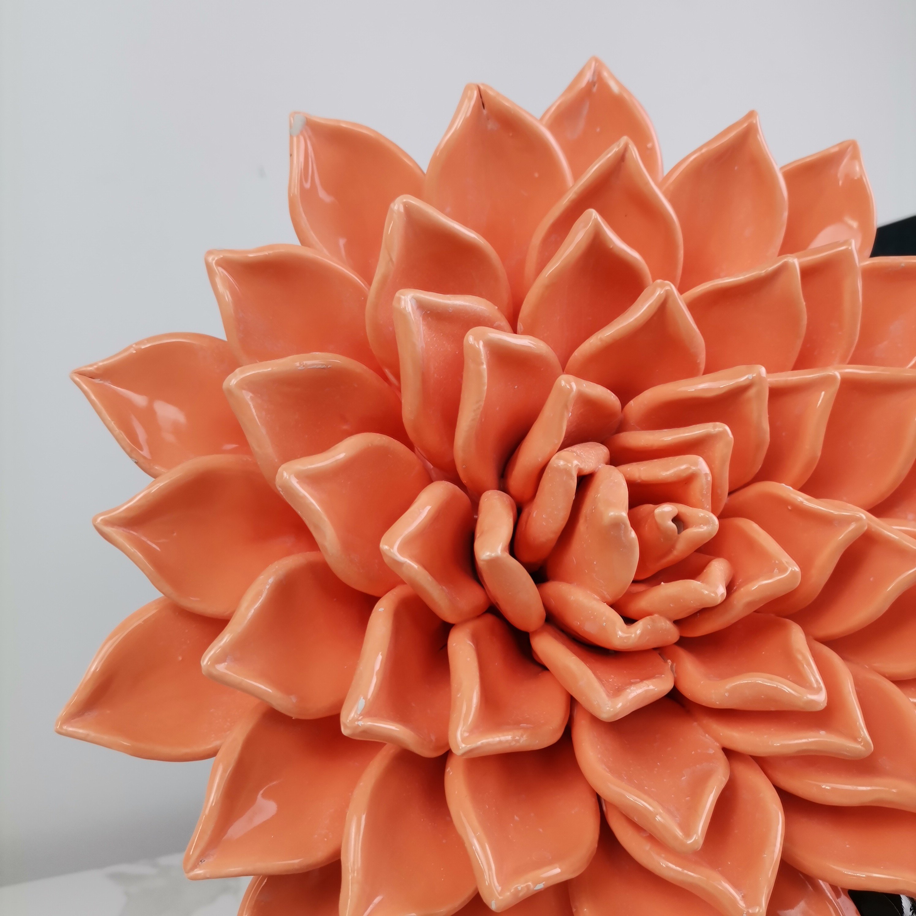 Sense of design Wall decorated with hanging ceramic handmade flowers artistic flowers
