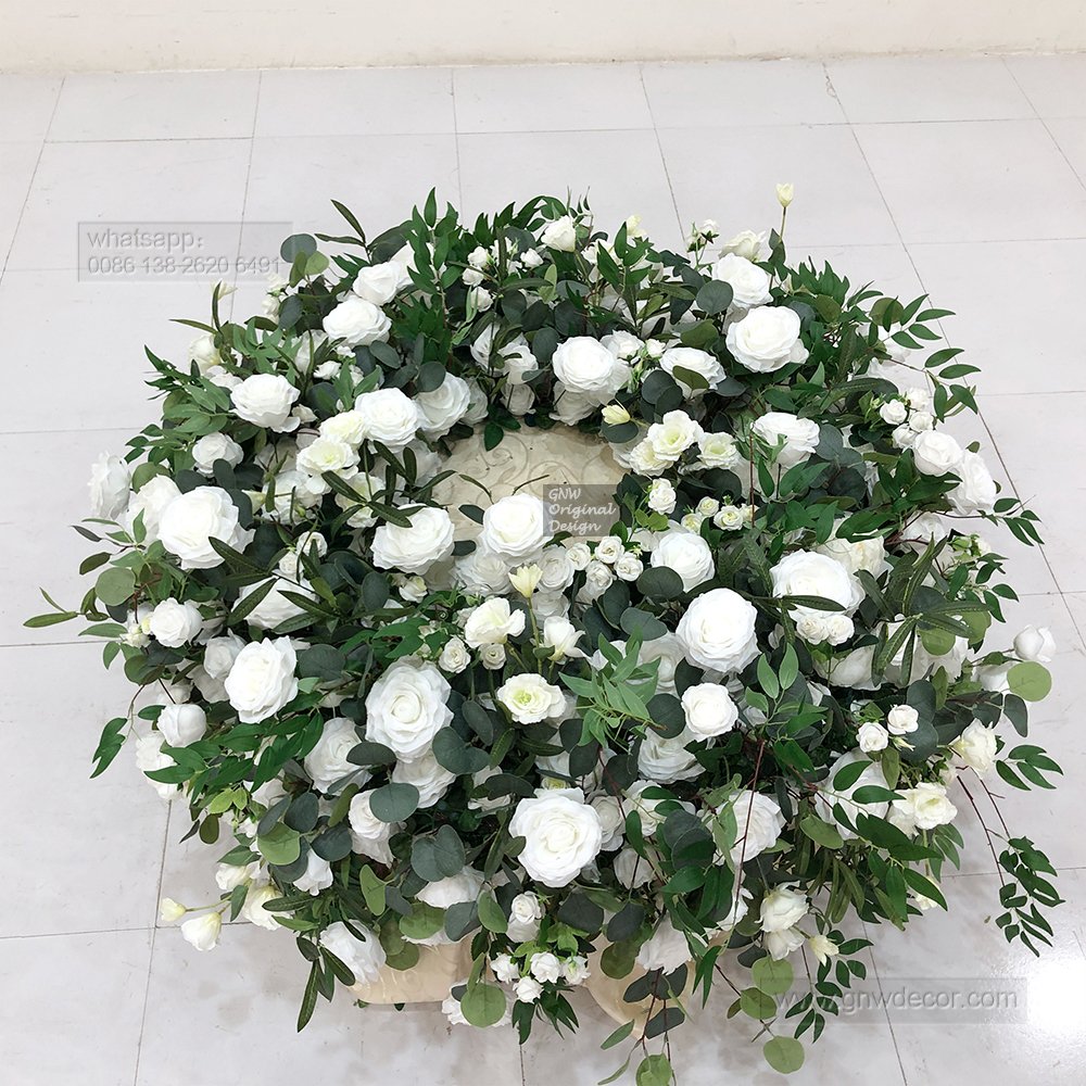 Elegant wedding artificial green white rose arrangement decorated foliage cake table florals