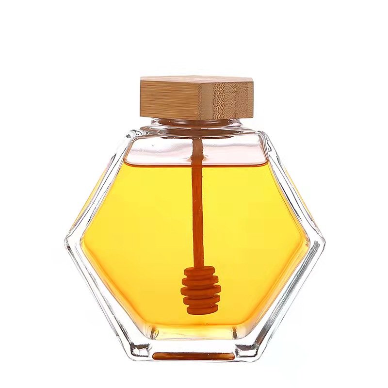 Fancy Empty Hexagon Food Storage Sealed Tank Honey Jar Container Glass Honey Jam Jars With Wooden Lid And Spoon