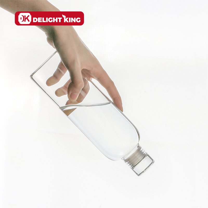 High Borosilicate Custom Logo Clear Glass drinking Bottle Luxury Style Smooth Glass Water Bottle With Sealing Glass lid