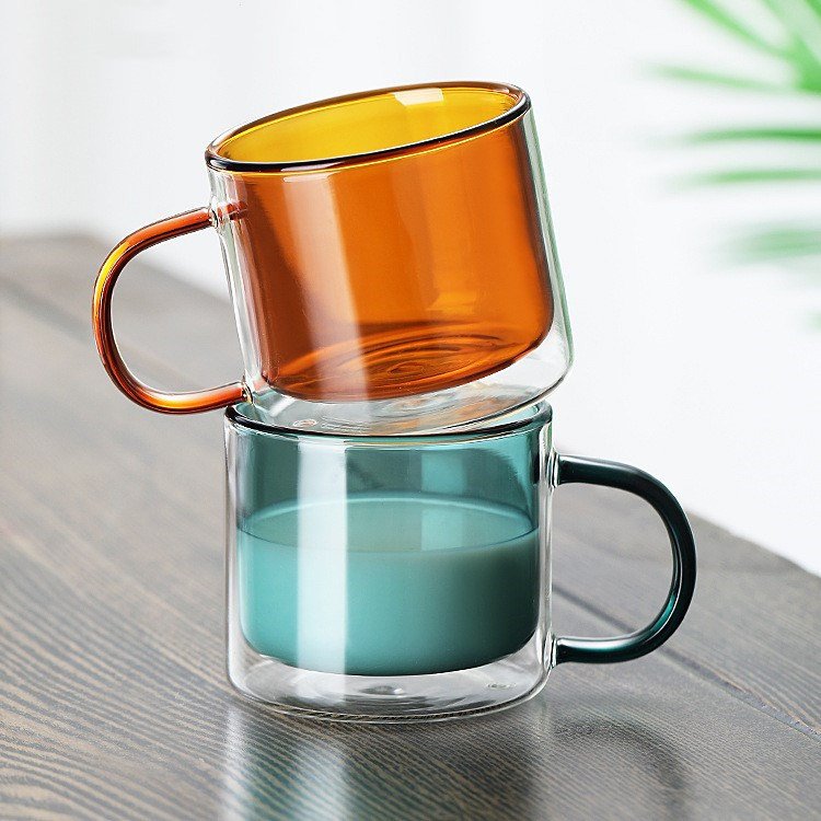 Clear cylindrical coffee mug with heat resistant handle and coloured double wall glass mug