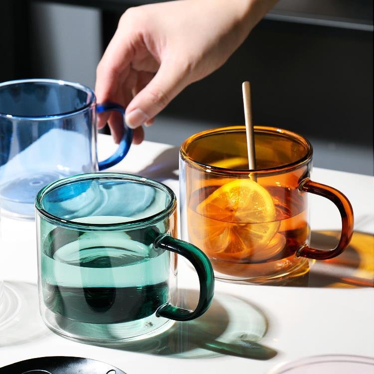 Clear cylindrical coffee mug with heat resistant handle and coloured double wall glass mug