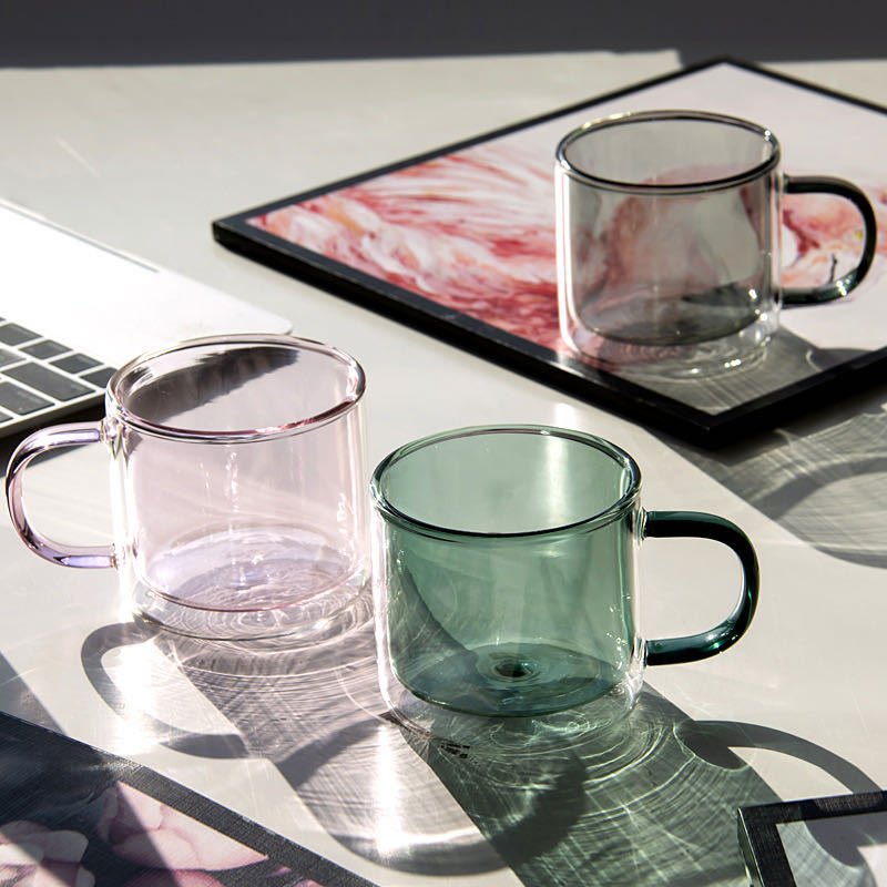 Clear cylindrical coffee mug with heat resistant handle and coloured double wall glass mug