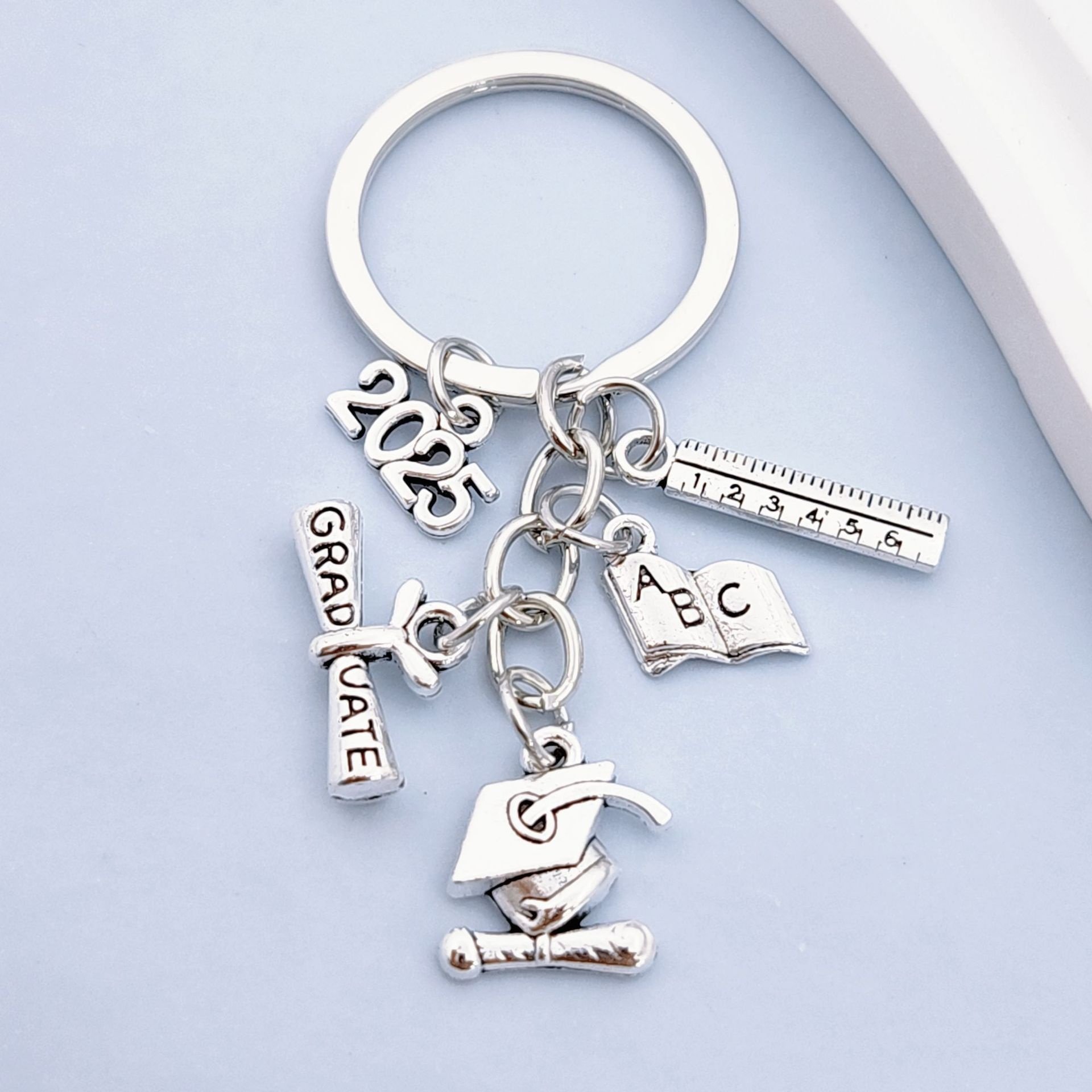 2025 European American Fashion Light Keychain Bachelor's Hat Key Ring Book Roll Graduation Badge Metal Cross-Border Wholesale