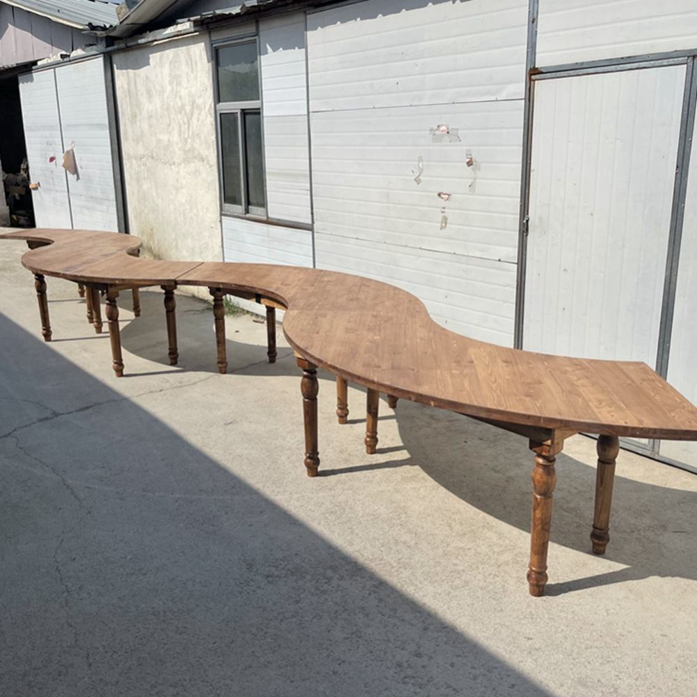 This garden curved wooden outdoor table features rustic seating perfect for outdoor picnics and event weddings