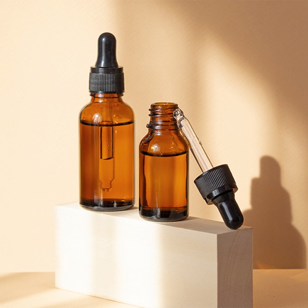 Personalized glass dropper bottle with plastic dropper cap for essential oil applications