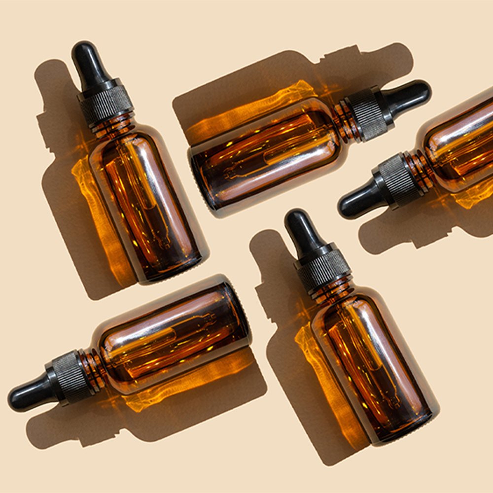 Personalized glass dropper bottle with plastic dropper cap for essential oil applications