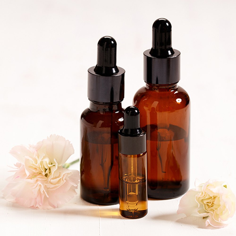 Personalized glass dropper bottle with plastic dropper cap for essential oil applications