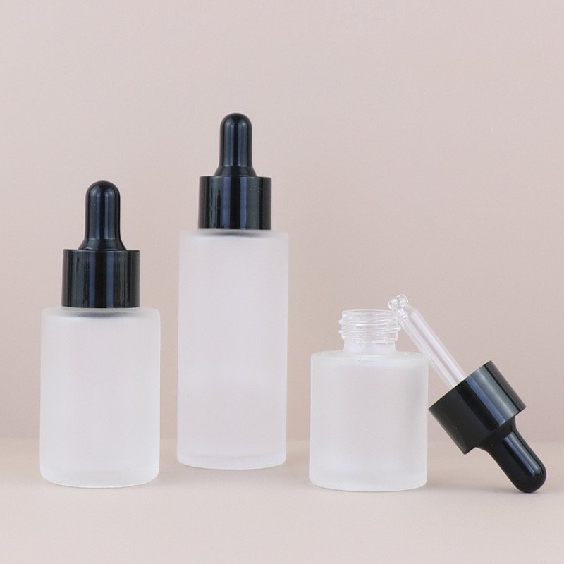 Cosmetic skincare essential oil bottle luxury flat shoulder frosted clear glass bottle 30ml with black lids