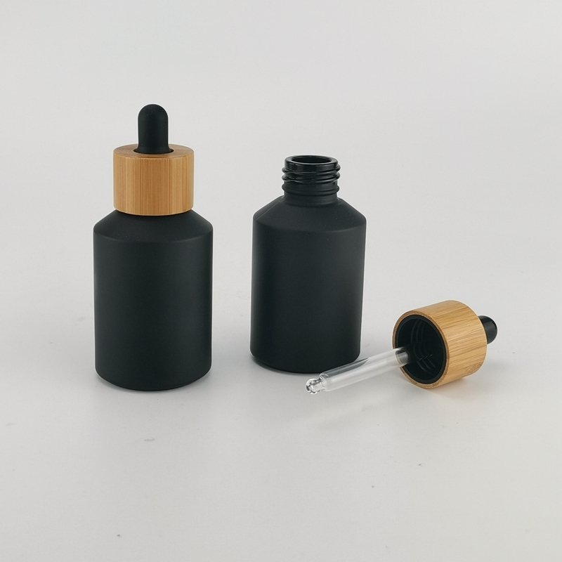 sloping shoulder glass bottle 60 ml matte black glass bottle 2 oz black frosted glass bottle with bamboo screw lid for cosmetic