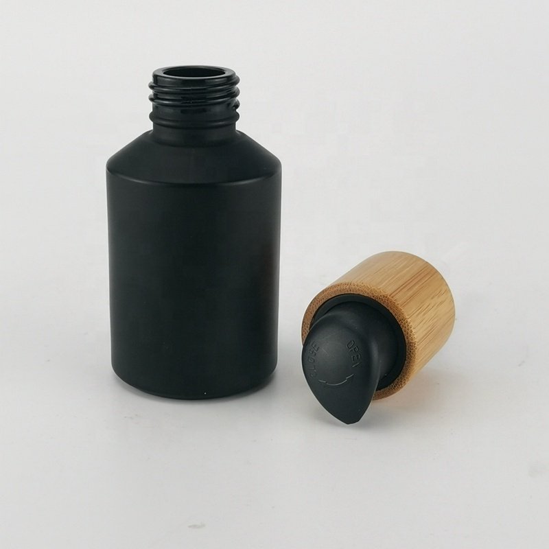 sloping shoulder glass bottle 60 ml matte black glass bottle 2 oz black frosted glass bottle with bamboo screw lid for cosmetic