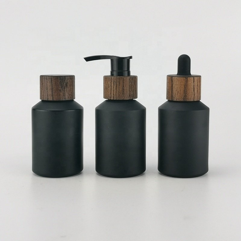 sloping shoulder glass bottle 60 ml matte black glass bottle 2 oz black frosted glass bottle with bamboo screw lid for cosmetic