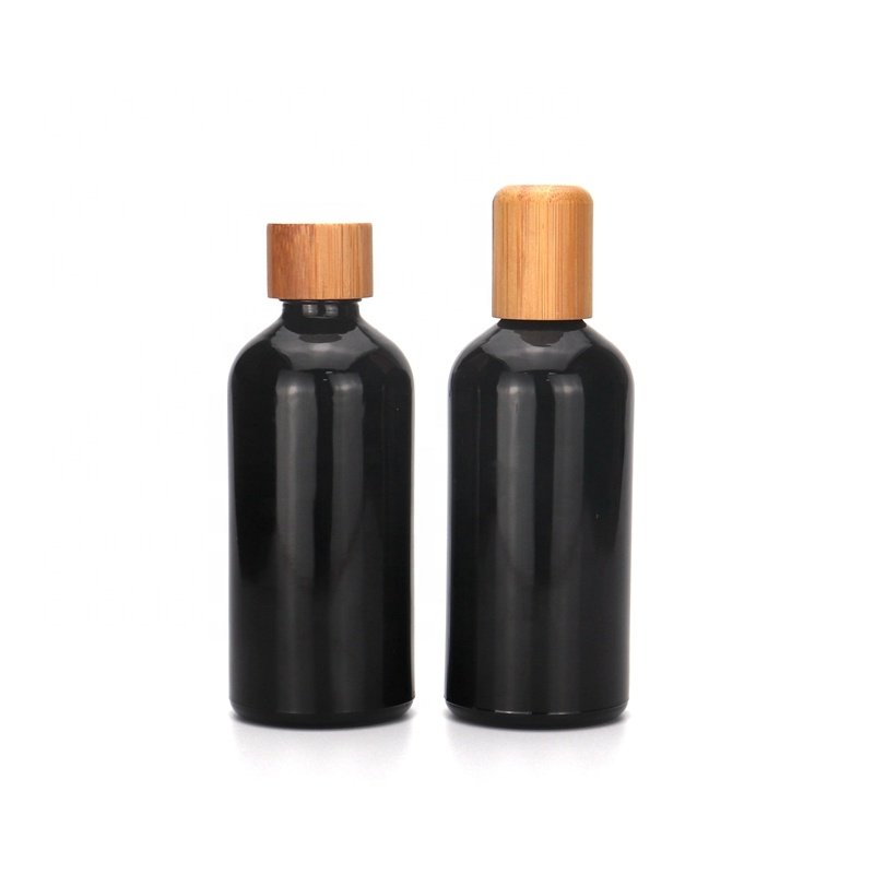 essential oil bottle 10ml 15ml 30ml 50ml 100ml empty cosmetic black glass bottle with bamboo cap reducer for body massage oil