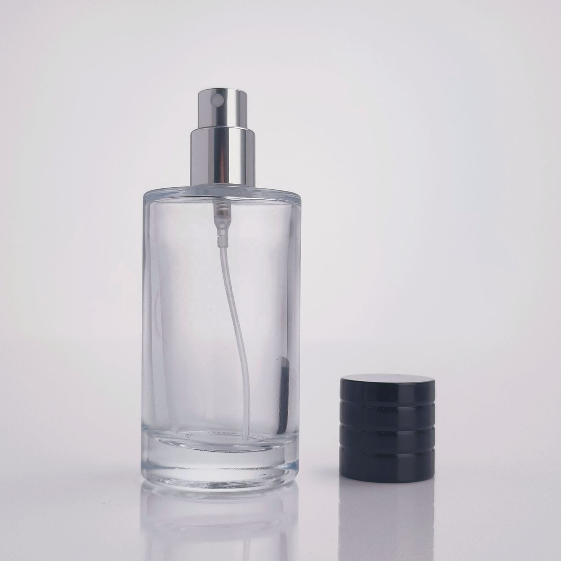 Glass perfume bottles 25ml 50ml 100ml wholesale luxury round transparent empty oil glass spray bottle with sprayer atomizer