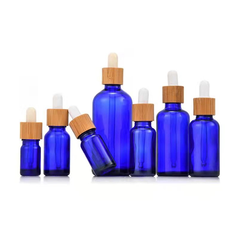 Wholesale empty matte blue amber green frosted glass dropper bottle with wooden cap for essential oil glass bottle bamboo lid