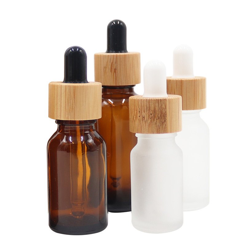 Wholesale empty matte blue amber green frosted glass dropper bottle with wooden cap for essential oil glass bottle bamboo lid