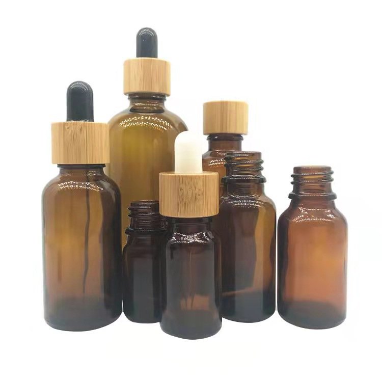 Wholesale empty matte blue amber green frosted glass dropper bottle with wooden cap for essential oil glass bottle bamboo lid