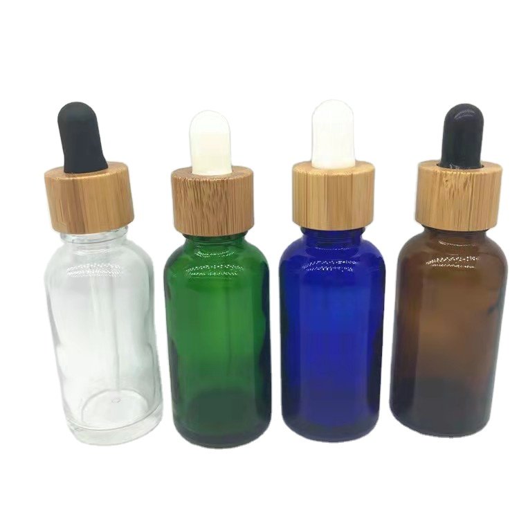 Wholesale empty matte blue amber green frosted glass dropper bottle with wooden cap for essential oil glass bottle bamboo lid
