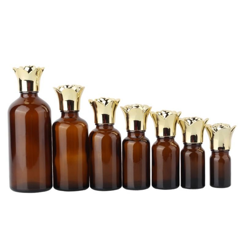 Hot selling cylindrical amber glass bottle with gold-plated rose cover and brown essential oil glass bottle