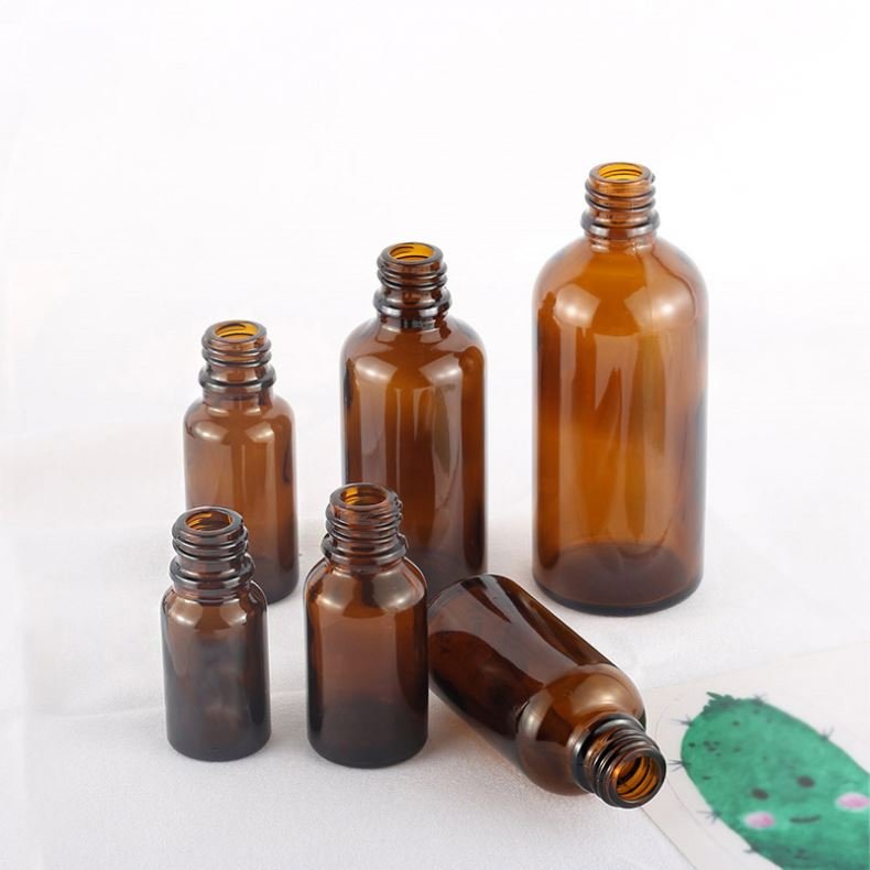 Hot selling cylindrical amber glass bottle with gold-plated rose cover and brown essential oil glass bottle