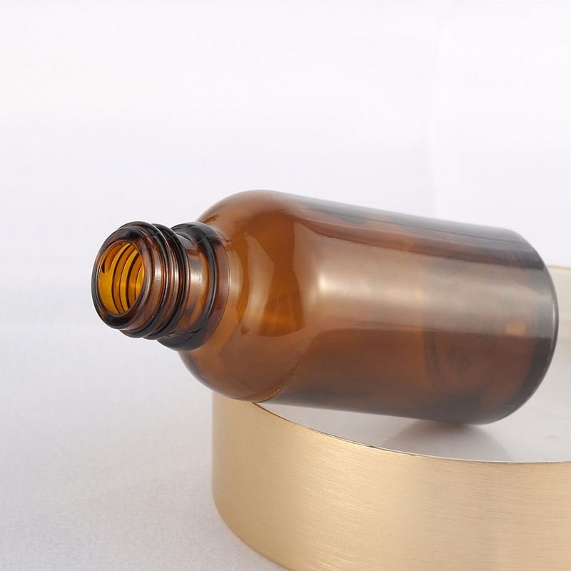 Hot selling cylindrical amber glass bottle with gold-plated rose cover and brown essential oil glass bottle