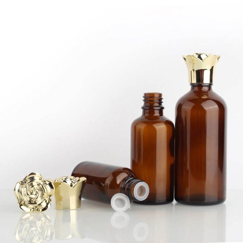 Hot selling cylindrical amber glass bottle with gold-plated rose cover and brown essential oil glass bottle