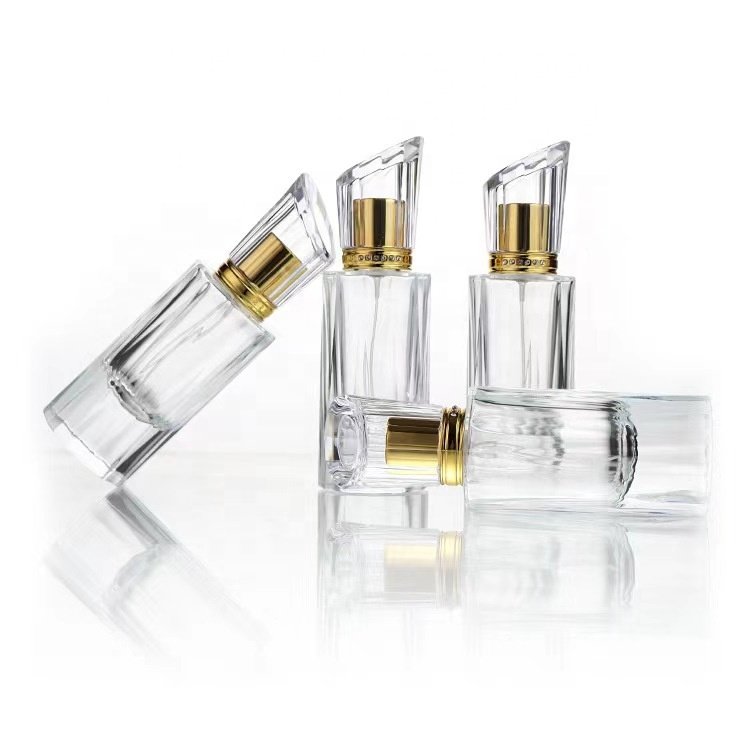 Empty luxury perfume glass bottles wholesale 50ml round glass perfume bottles cosmetic glass spray bottle with pump atomizer