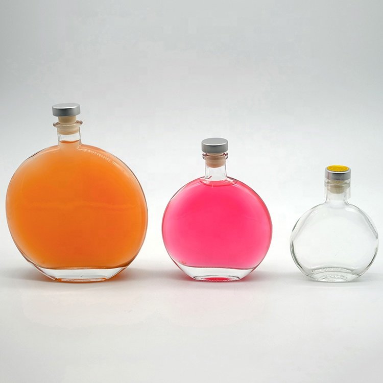 Factory wholesale 500ml gin glass bottle round shape vodka liquor bottle with cork custom logo whisky glass bottle