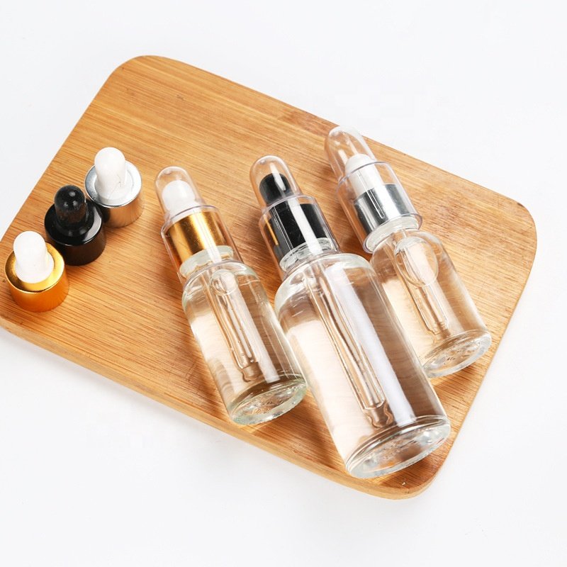 Essential Oil Bottle Cosmetic Glass with Gold Dropper 5ml-100ml Sizes Clear & Black with Paint Surface Handling Screen Printing