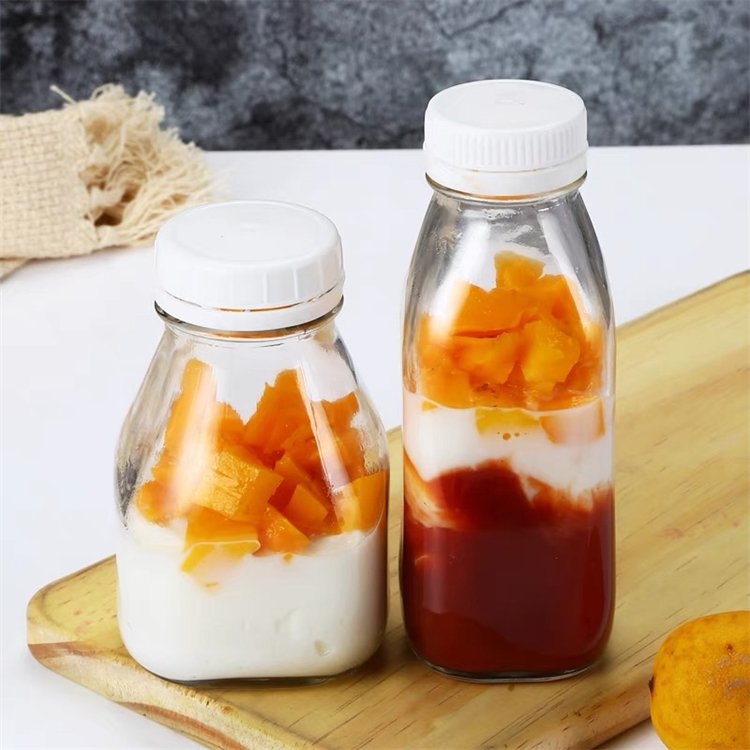 Wholesale square reusable tea beverage drinking 300ml 500ml empty milk glass juice bottles with cap