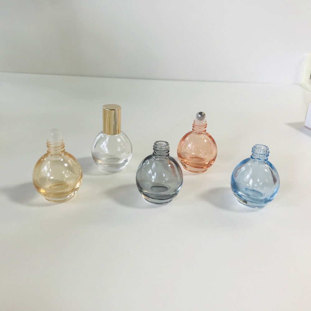 Wholesale 10ml rounded shape blue clear pink yellow grey metallic roll on essential oil glass bottle with shiny gold cap