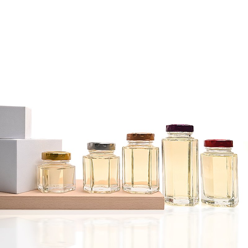 China Wholesale Cheap Custom Empty Clear Food Grade Storage Hexagonal Glass Honey Jam Jar with Screw Lids