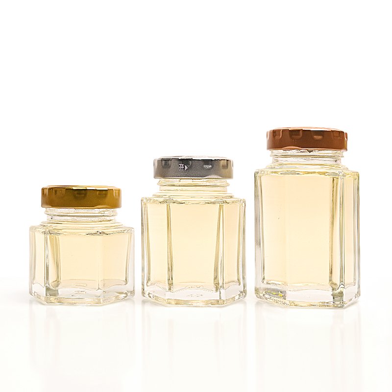 China Wholesale Cheap Custom Empty Clear Food Grade Storage Hexagonal Glass Honey Jam Jar with Screw Lids