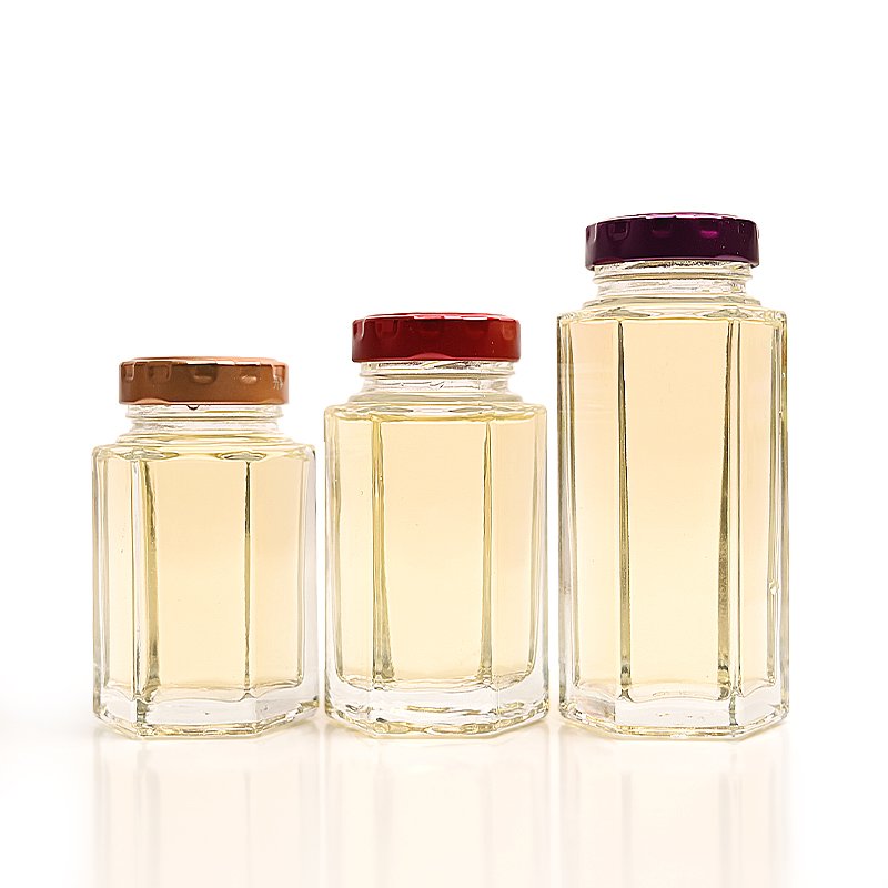China Wholesale Cheap Custom Empty Clear Food Grade Storage Hexagonal Glass Honey Jam Jar with Screw Lids