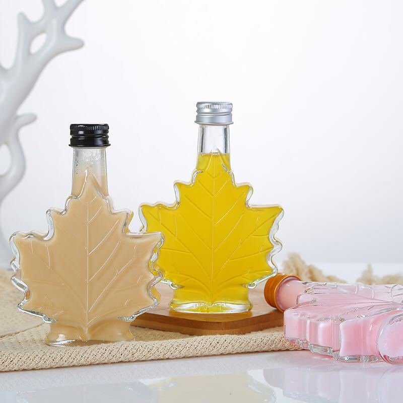 Unique 70ml 100ml 250ml Maple Leaf Shaped Glass Bottle Glass Beverage Bottle Dark Rum bottle with Screw Cap