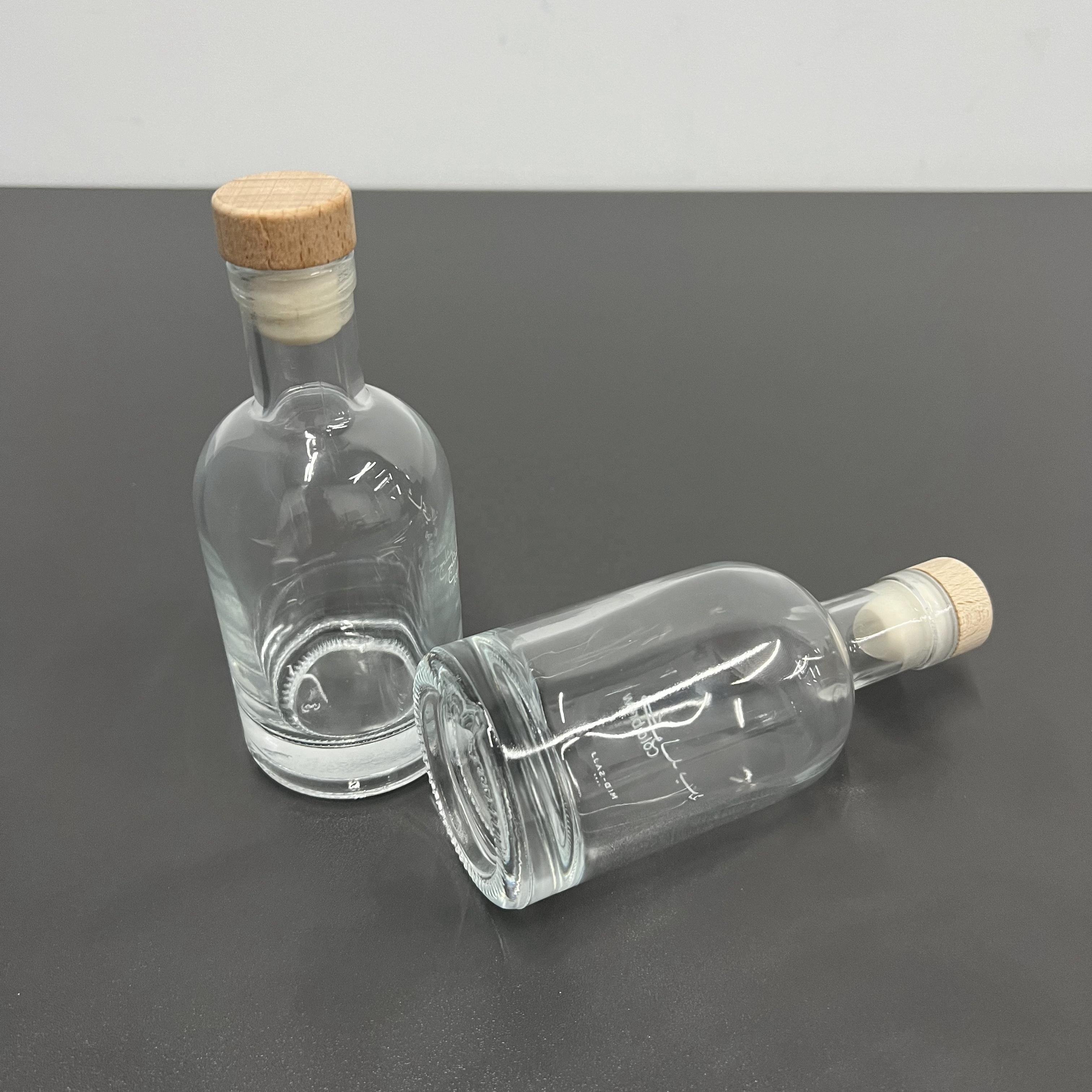 Best quality cheap customized logo printed transparent clear fruit juice wine packaging glass bottle with cork for beverage shop