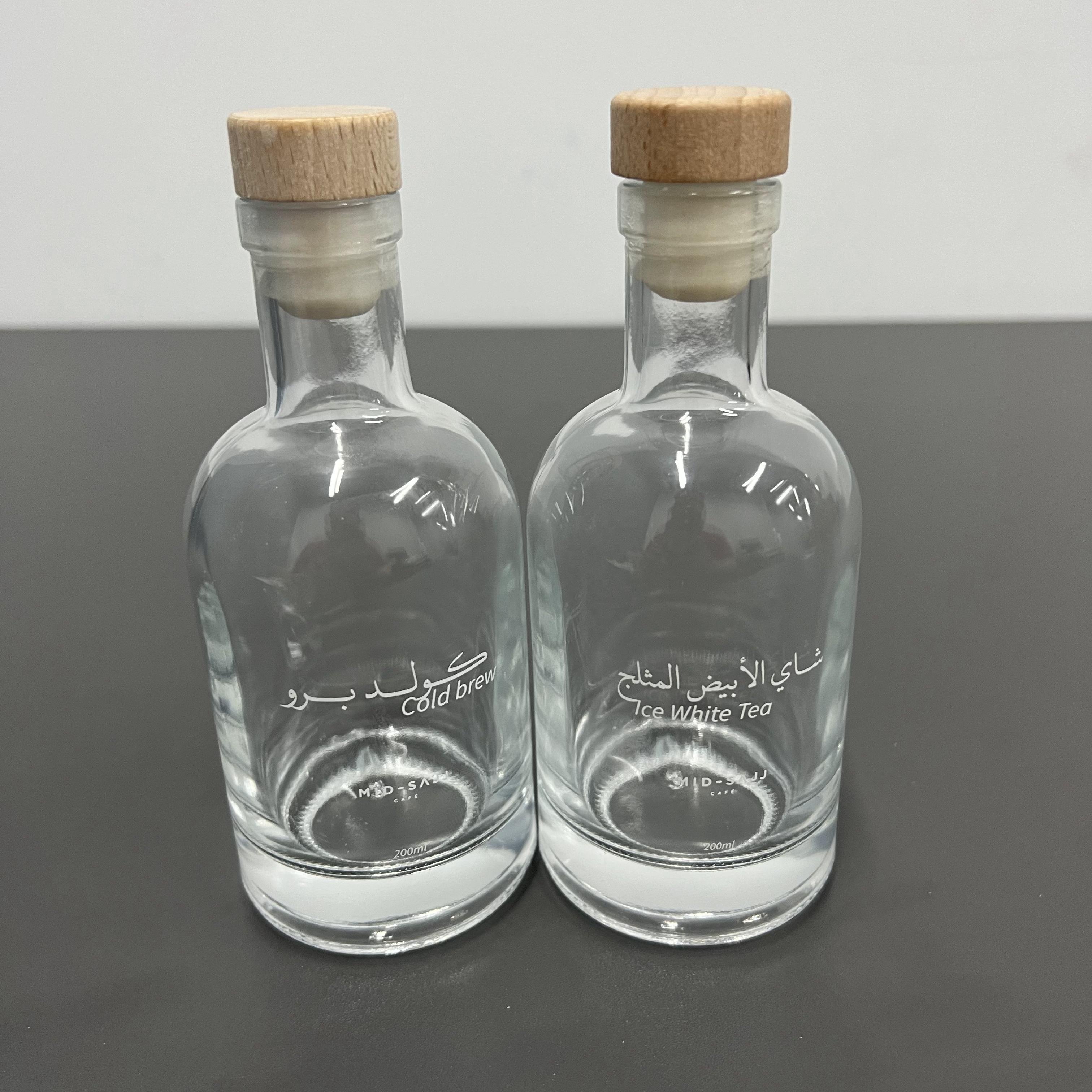 Best quality cheap customized logo printed transparent clear fruit juice wine packaging glass bottle with cork for beverage shop
