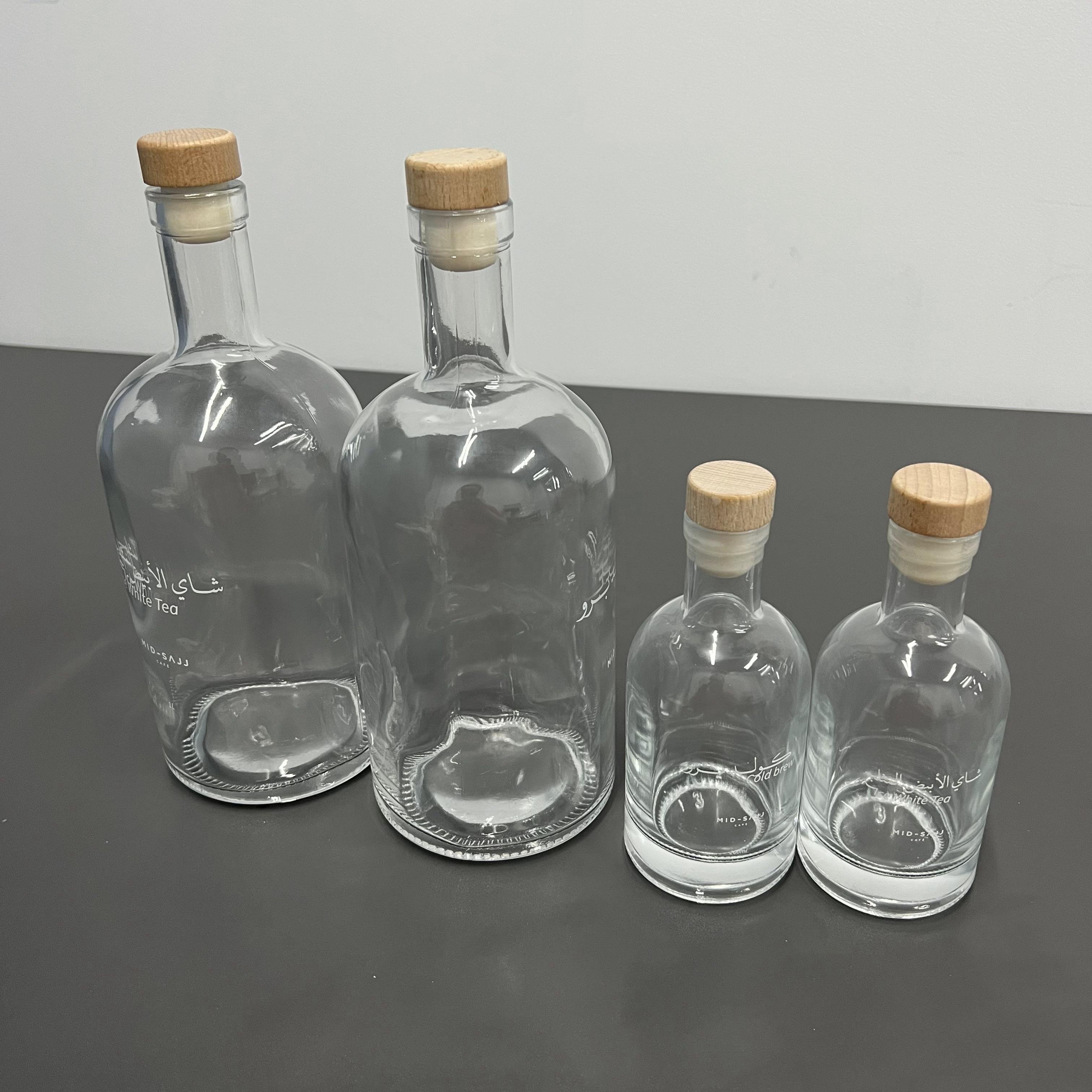 Best quality cheap customized logo printed transparent clear fruit juice wine packaging glass bottle with cork for beverage shop