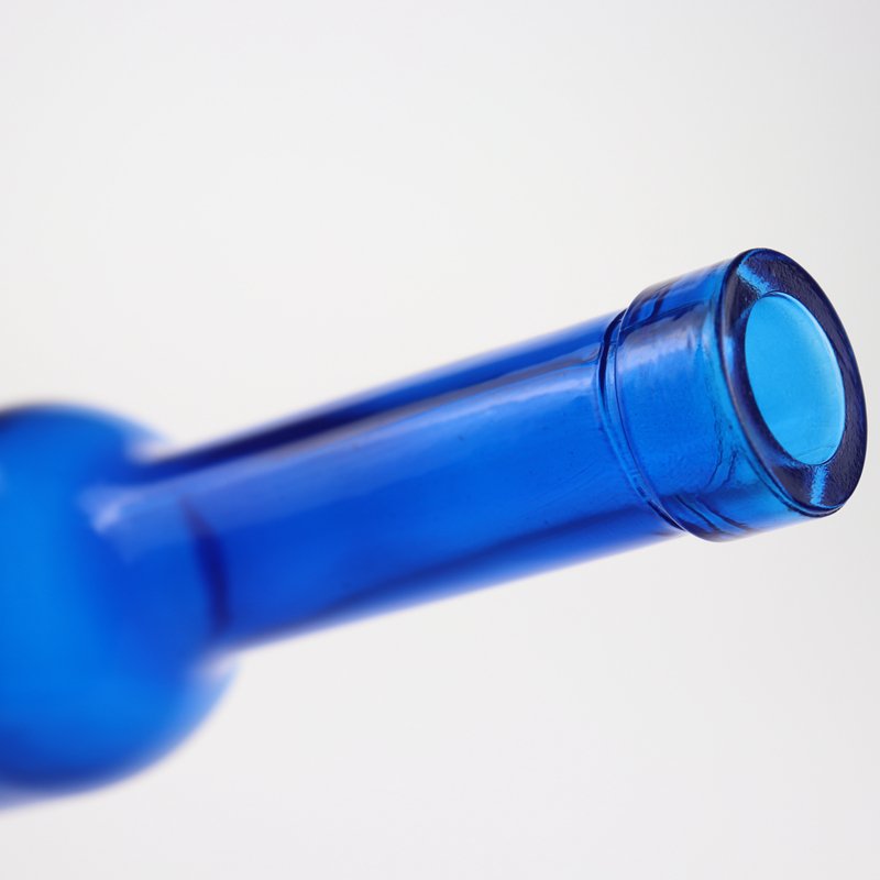 Low price and MOQ Drop shape cobalt blue spirit glass bottle fruit wine bottle tall thin beverage bottle